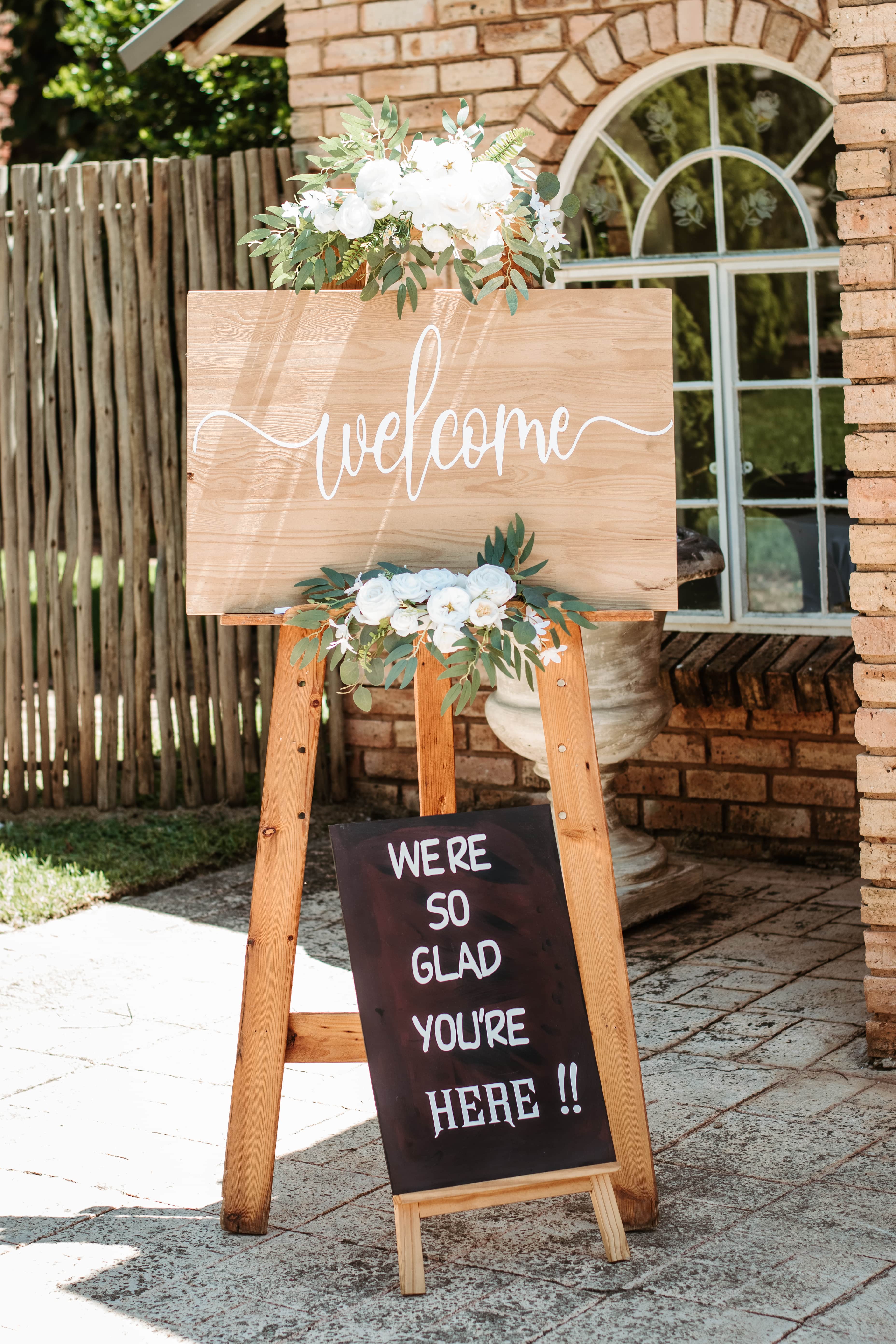 wooden lanterns with candles and eucalyptus garland at ceremony altar