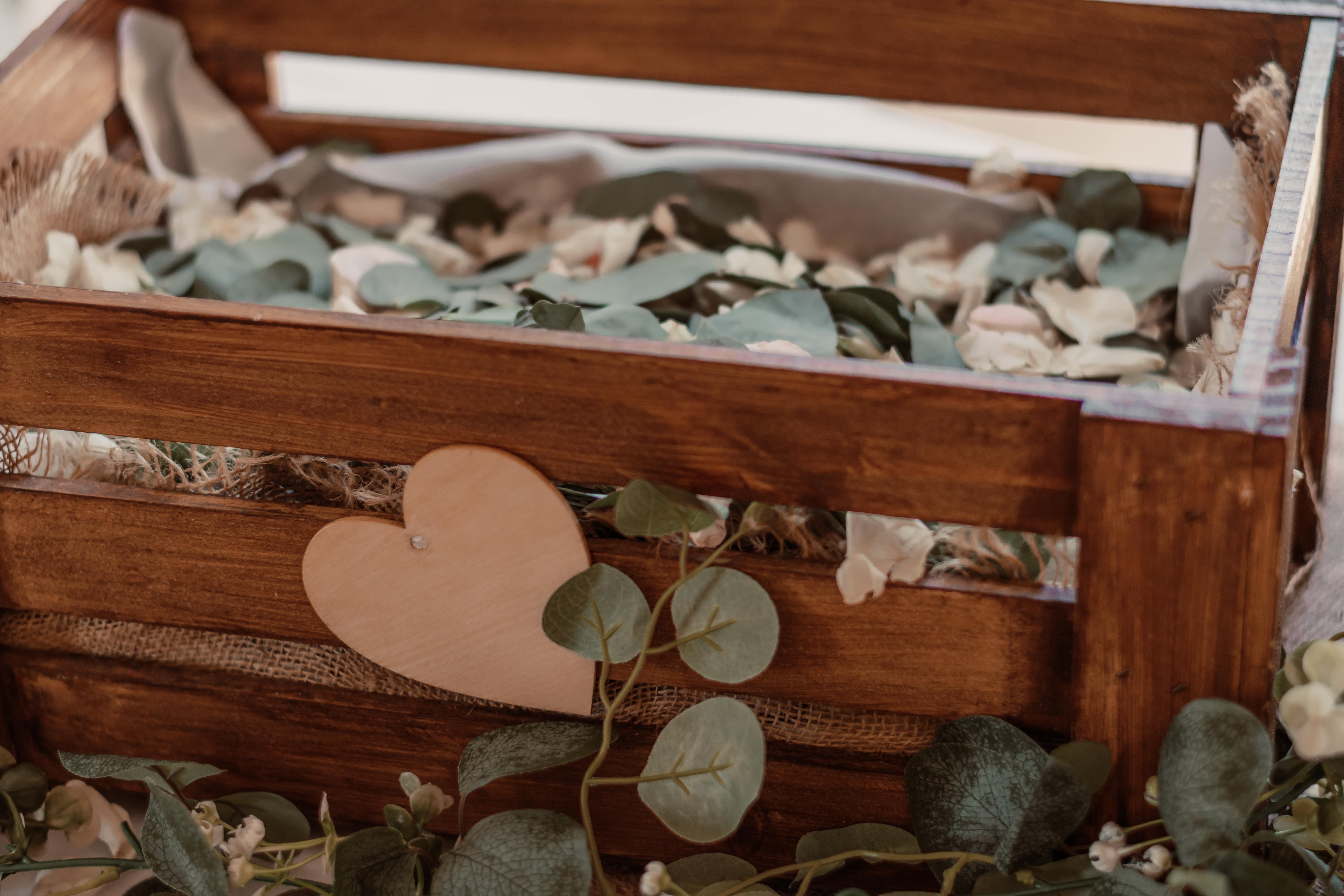 wooden crate centerpiece with eucalyptus and heart-shaped tags