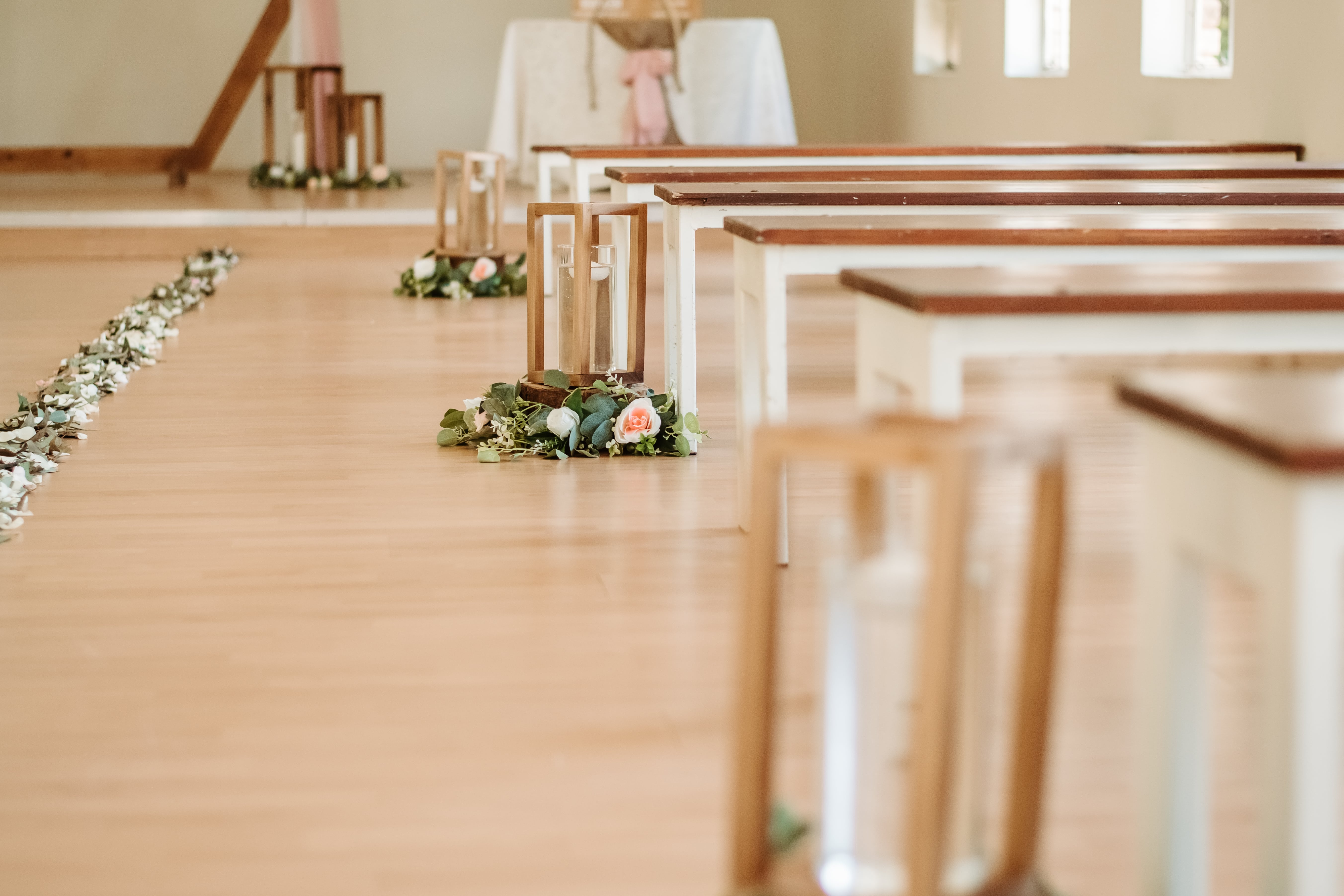 wedding ceremony chapel with wooden hexagon arch and petal aisle