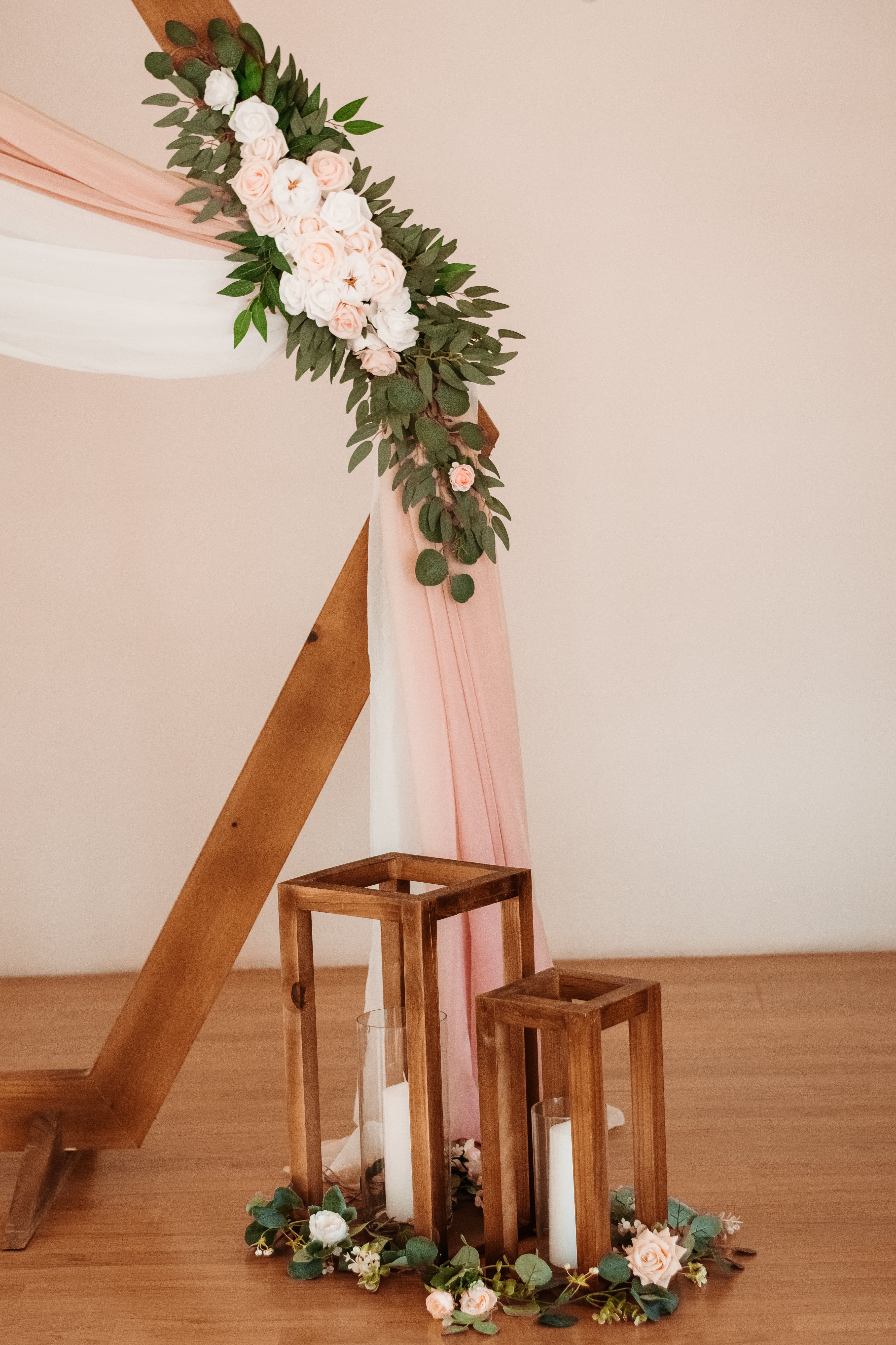 ceremony aisle with wooden lanterns and eucalyptus arrangements